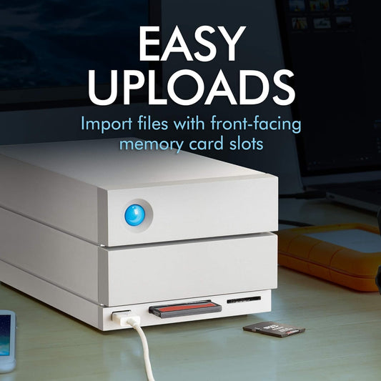 A LaCie 2big Dock Thunderbolt 3 Hardware RAID, 8TB, sits on a desk with a memory card inserted in its front-facing slot and a USB cable connected. Text: Easy Uploads. Import files easily via the convenient front-facing memory card slots.