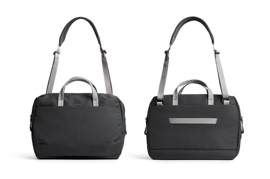 Zwei Bellroy Via Work Bags (Tech Briefcase) in der Farbe „Slate“ sind nebeneinander abgebildet und zeigen die Vorder- und Rückansicht. Die eleganten schwarzen Taschen verfügen über graue Griffe und Riemen; eine hat ein kompaktes Reißverschlussfach, während die andere mit einer horizontalen Außentasche ausgestattet ist – perfekt als Laptoptasche oder wasserfeste Laptoptasche geeignet, was sie ideal für Geschäftsreisen macht.