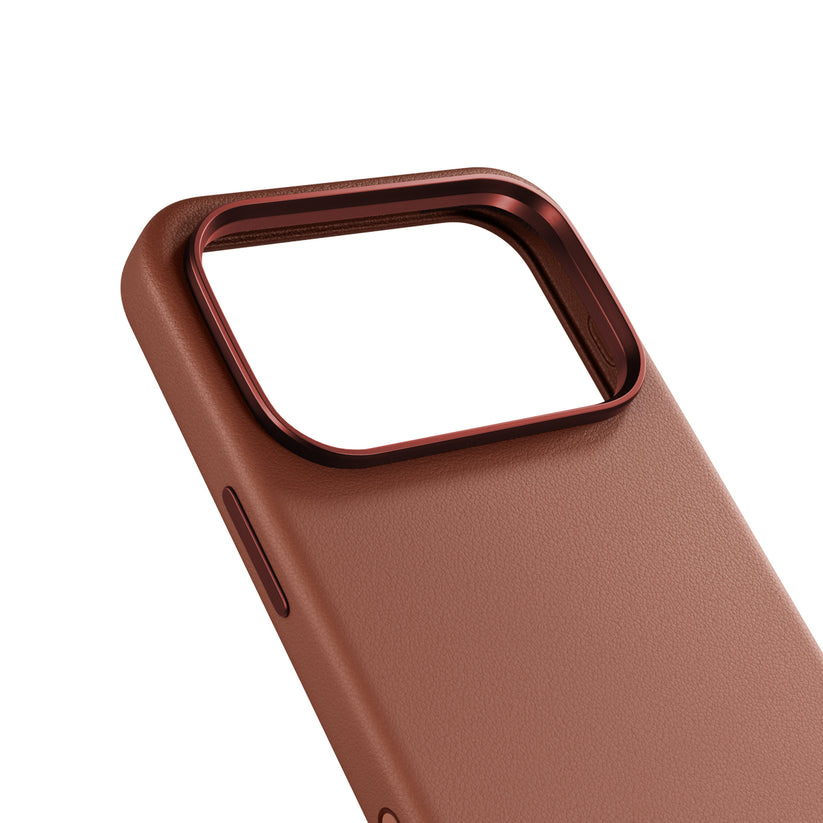 Epico’nun iPhone 17 Pro/18 Pro için ürettiği kahverengi Leder Case’in yakın çekim görüntüsü, beyaz bir arka plan üzerinde, sofistike kahverengi deri kaplamasını ve lens açıklığının etrafındaki kabartmalı, metalik kırmızı kamera çerçevesini sergiliyor. Epico tarafından zarif bir koruma sağlayan birinci sınıf bir iPhone 17 Pro kılıfı olarak kusursuz bir şekilde tasarlanmıştır.