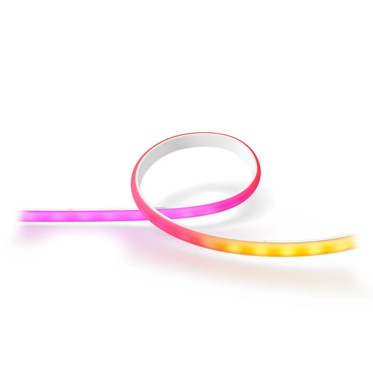 Ein flexibler Philips Hue Gradient Ambience Lightstrip 1m Erweiterung von Philips bildet eine lockere Schleife und leuchtet mit rosa, roten und gelben Farbverläufen vor einem weißen Hintergrund.