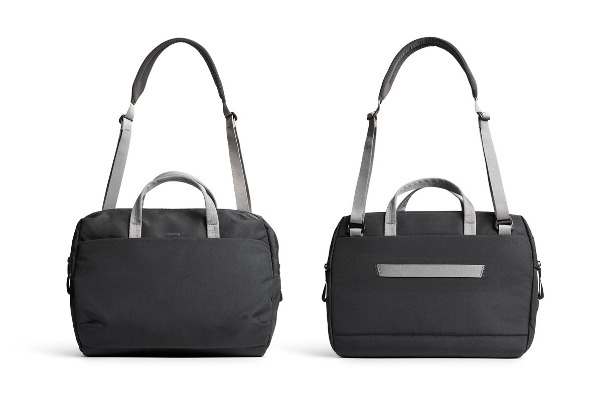 Zwei Bellroy Via Work Bags (Tech Briefcase) in der Farbe „Slate“ sind nebeneinander abgebildet und zeigen die Vorder- und Rückansicht. Die eleganten schwarzen Taschen verfügen über graue Griffe und Riemen; eine hat ein kompaktes Reißverschlussfach, während die andere mit einer horizontalen Außentasche ausgestattet ist – perfekt als Laptoptasche oder wasserfeste Laptoptasche geeignet, was sie ideal für Geschäftsreisen macht.