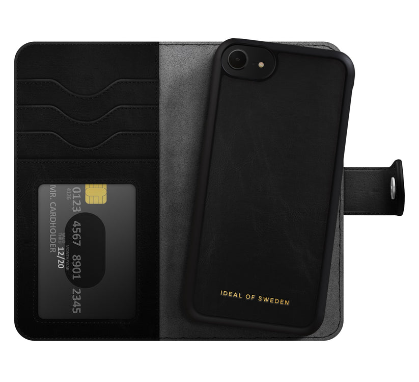 A black wallet phone case from Ideal of Sweden, designed for iPhone 8 / 7 / 6 / 6S / SE, with card slots and a visible credit card. Crafted from vegan materials, the case features “IDEAL OF SWEDEN” in gold lettering at the bottom and offers Magnet Wallet+ MagSafe compatibility for seamless everyday use.