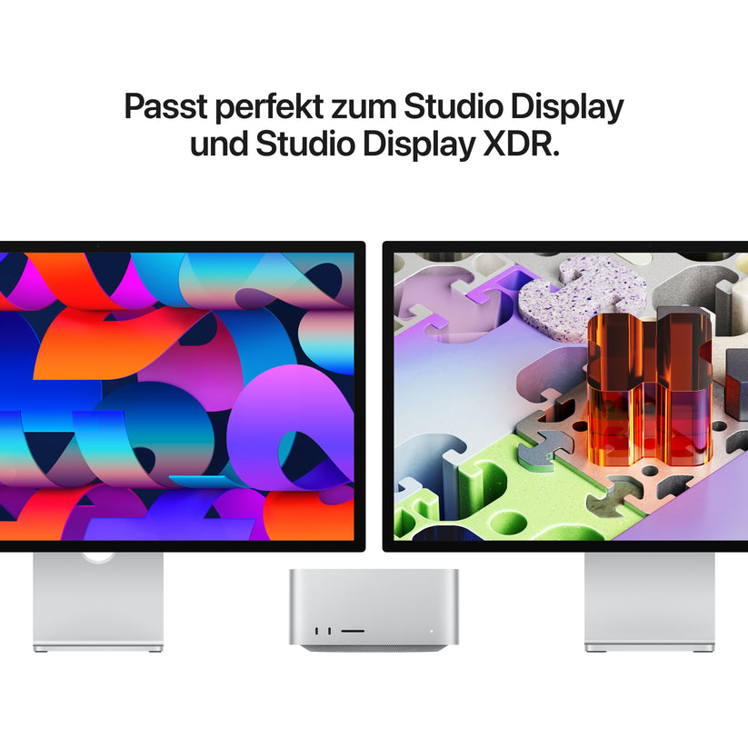 Zwei Computermonitore, auf denen farbenfrohe abstrakte Bilder zu sehen sind, stehen nebeneinander über einem kleinen silbernen Apple Mac Studio mit M5 Max-Chip, einer 18-Core-CPU, einer 32-Core-GPU, 36 GB RAM und einer 512 GB SSD; darüber ist ein deutscher Text zu sehen.