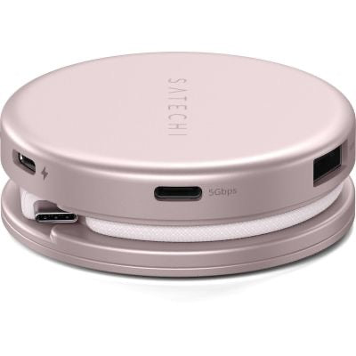 Der Satechi OntheGo 5-in-1-Multiport-Adapter (Blush) von Satechi ist ein runder Multiport-Hub in Roségold, der verschiedene Anschlussmöglichkeiten bietet und über ein weißes Spiralkabel verfügt, das sich ordentlich in der Basis verstauen lässt.